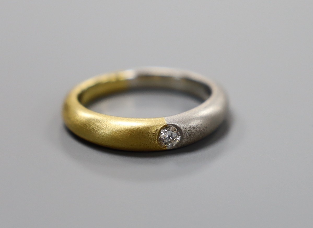 A modern sandblasted plat and 750 yellow metal ring, with gypsy set diamond, size M, gross weight 7.1 grams